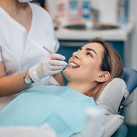 Woman smiling at her dentist during a checkup