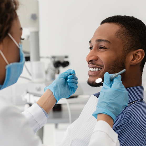 Man smiling at his dentist during a checkup