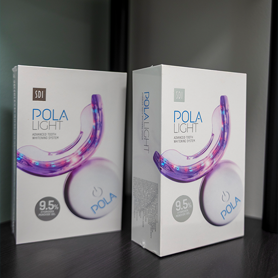 Two small boxes with take home teeth whitening kits