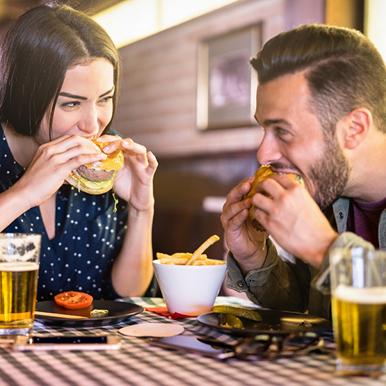 Man and woman enjoying burgers at a restaurant