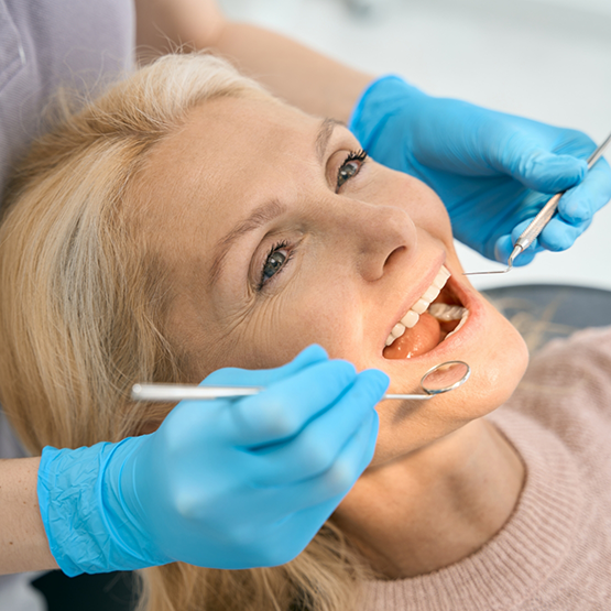 Woman having her teeth examined by her dentist