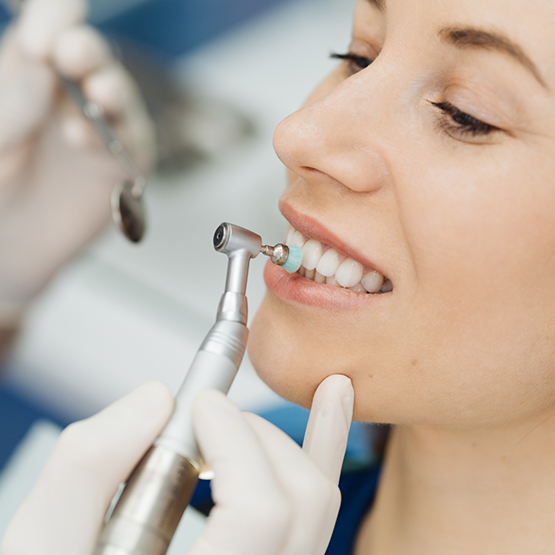 Woman in the dental chair getting a professional teeth cleaning