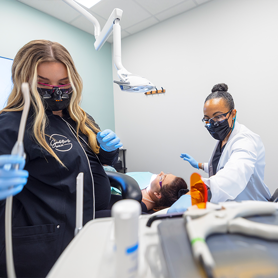 Goodlettsville dentist and assistant performing a dental procedure on a patient