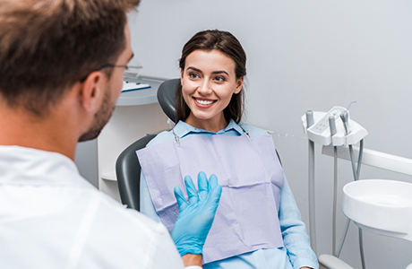Woman in the dental chair listening to her dentist