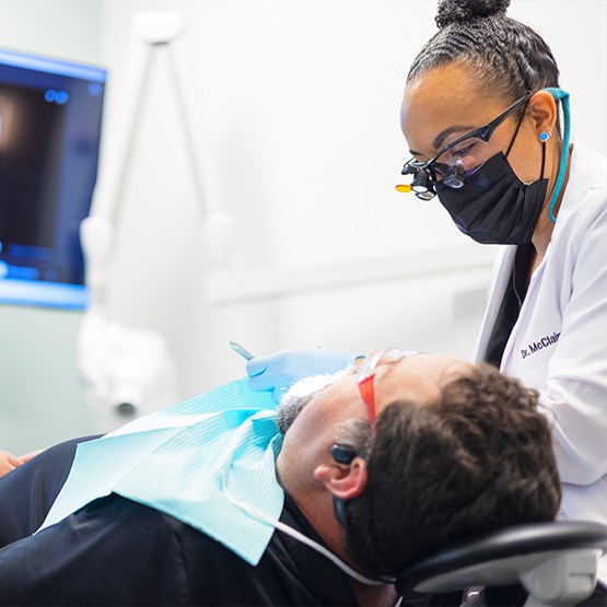 Doctor McClain exmaining a patient's mouth