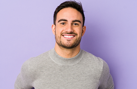 Smiling man in a gray sweater