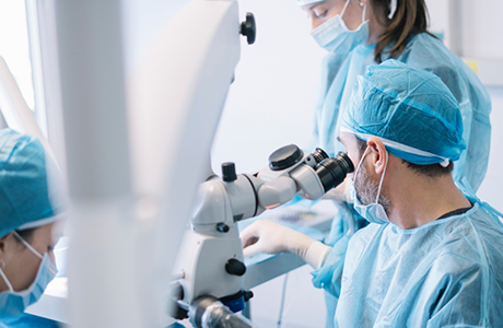 Dental team performing dental implant surgery on a patient