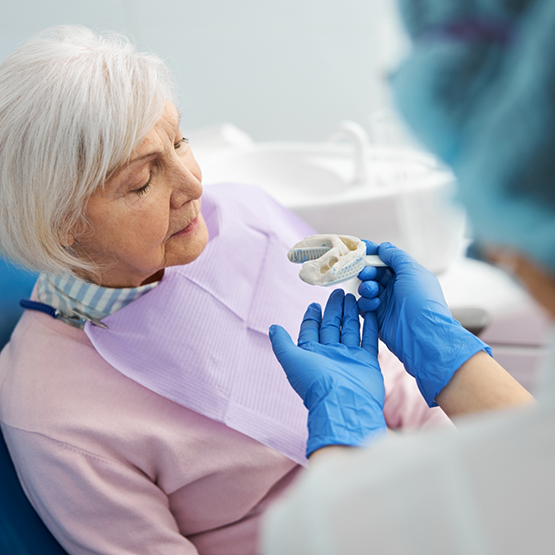 Dentist taking impressions of a senior woman's teeth