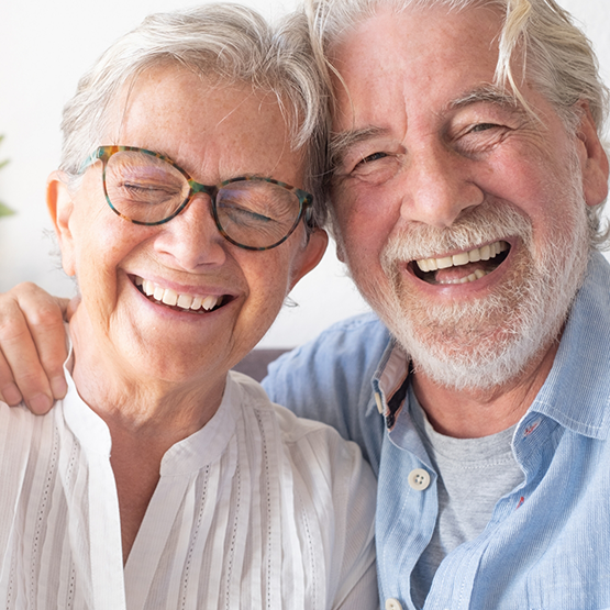 Senior man and woman grinning together