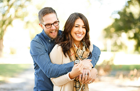 Young man and woman embracing in a park