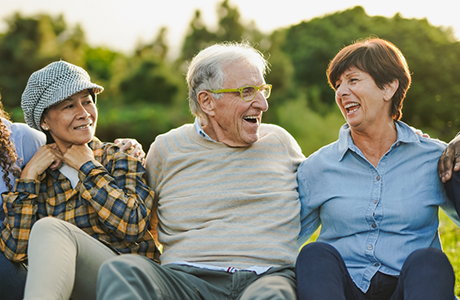 Group of seniors laughing together outdoors