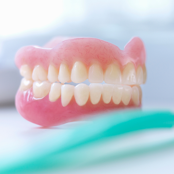Dentures next to a toothbrush