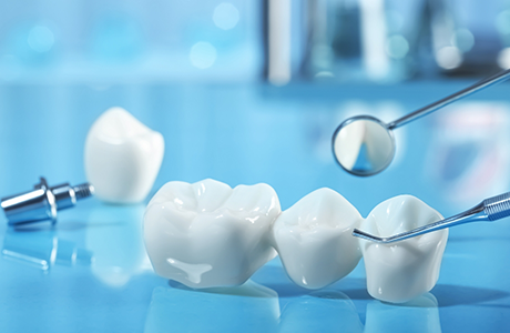 Dental bridge next to a dental mirror