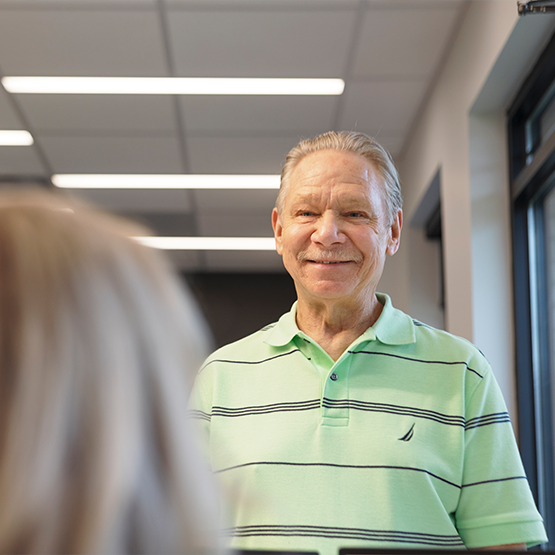 Man smiling at receptionist in dental office