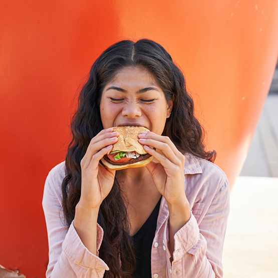 Woman biting into a burger