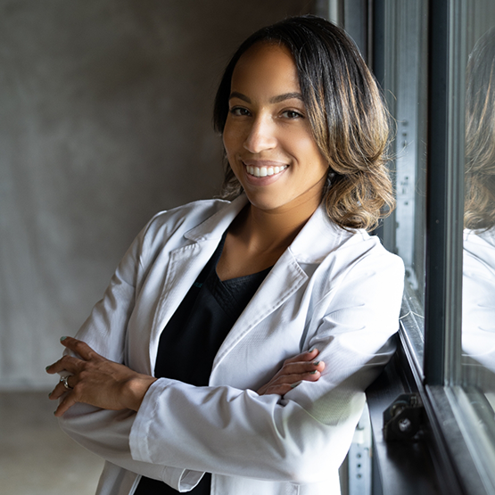 Doctor McClain smiling in a white lab coat