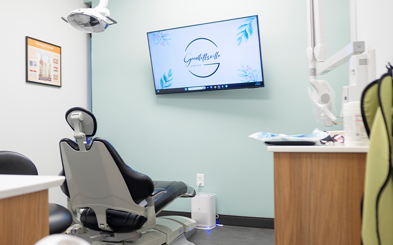 Dental treatment room with a television mounted on the wall