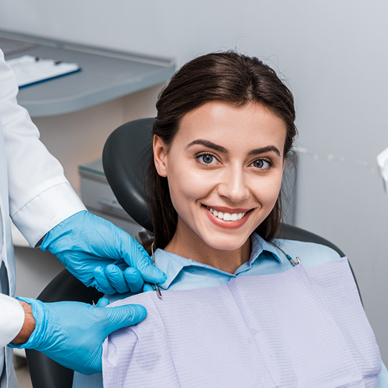 Brunette woman in the dental chair smiling