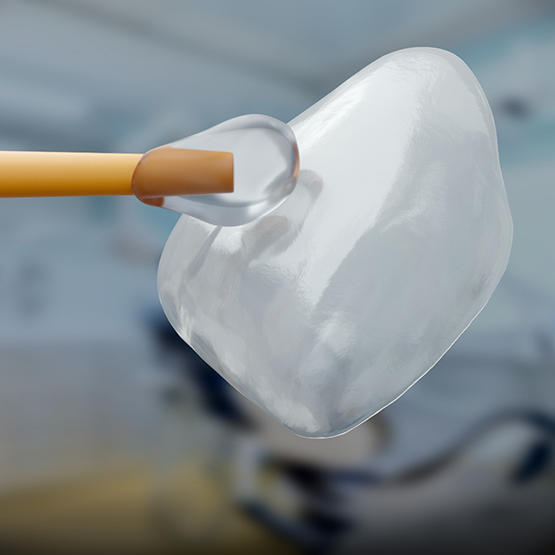 Adhesive material being applied to one side of a veneer