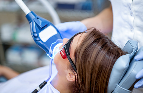 Woman in the dental chair getting professional teeth whitening