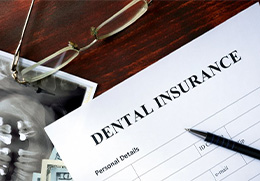 a dental insurance form next to an X-ray image