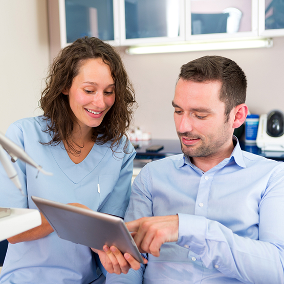 Cigna dentist showing a tablet to a Goodlettsville dental patient