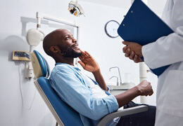 patient smilign while talking to dentist at appointment