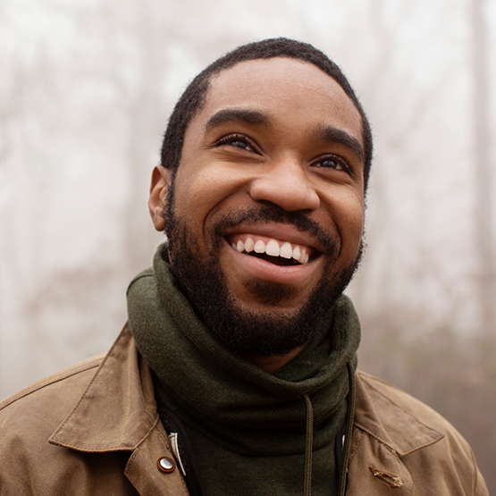 Man in a sweater smiling with dental bridges in Goodlettsville