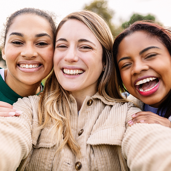 Selfie of three young women smiling outdoors after a dental checkup