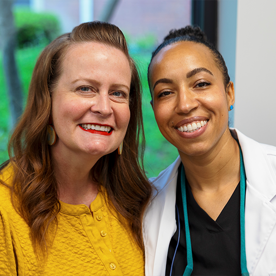 Doctor McClain smiling with a dental patient with dental crowns in Goodlettsville