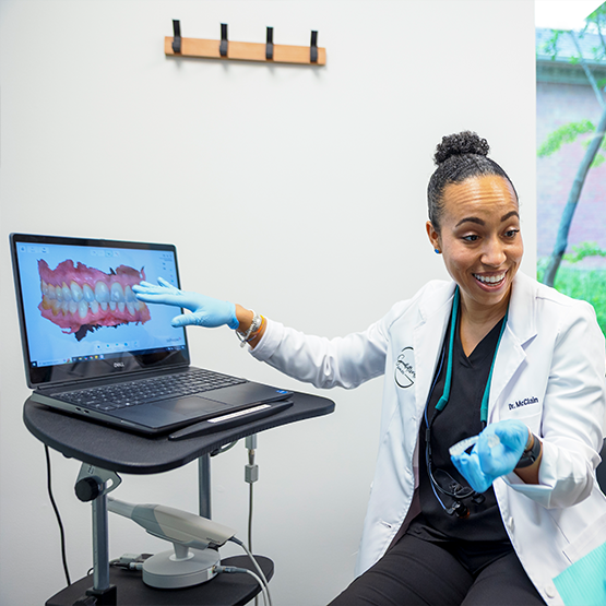 Doctor McClain showing a patient a digital scan of their teeth