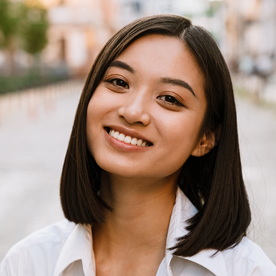 Brunette woman smiling after periodontal disease treatment in Goodlettsville