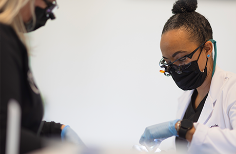 Doctor McClain and a dental assistant treating a patient