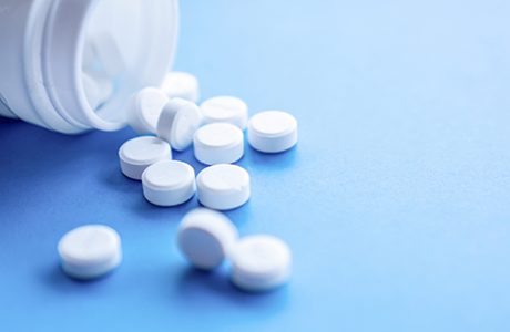 Bottle of white pills spilling out