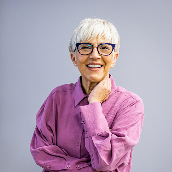 Senior woman smiling after getting implant dentures in Goodlettsville