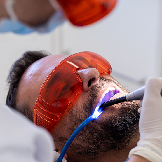 Dental patient having his mouth examined by his dentist