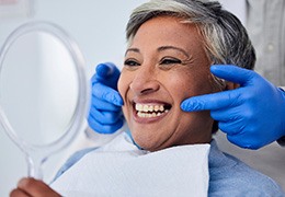 Woman smiling at reflection in mirror