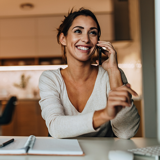 Smiling woman talking on the phone with her United Healthcare dentist in Goodlettsville