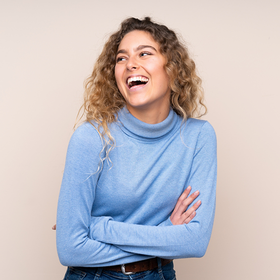 Woman in a light blue sweater smiling with veneers in Goodlettsville