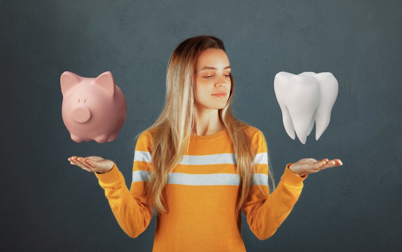 A woman holding up a 3D piggy bank and a 3D tooth